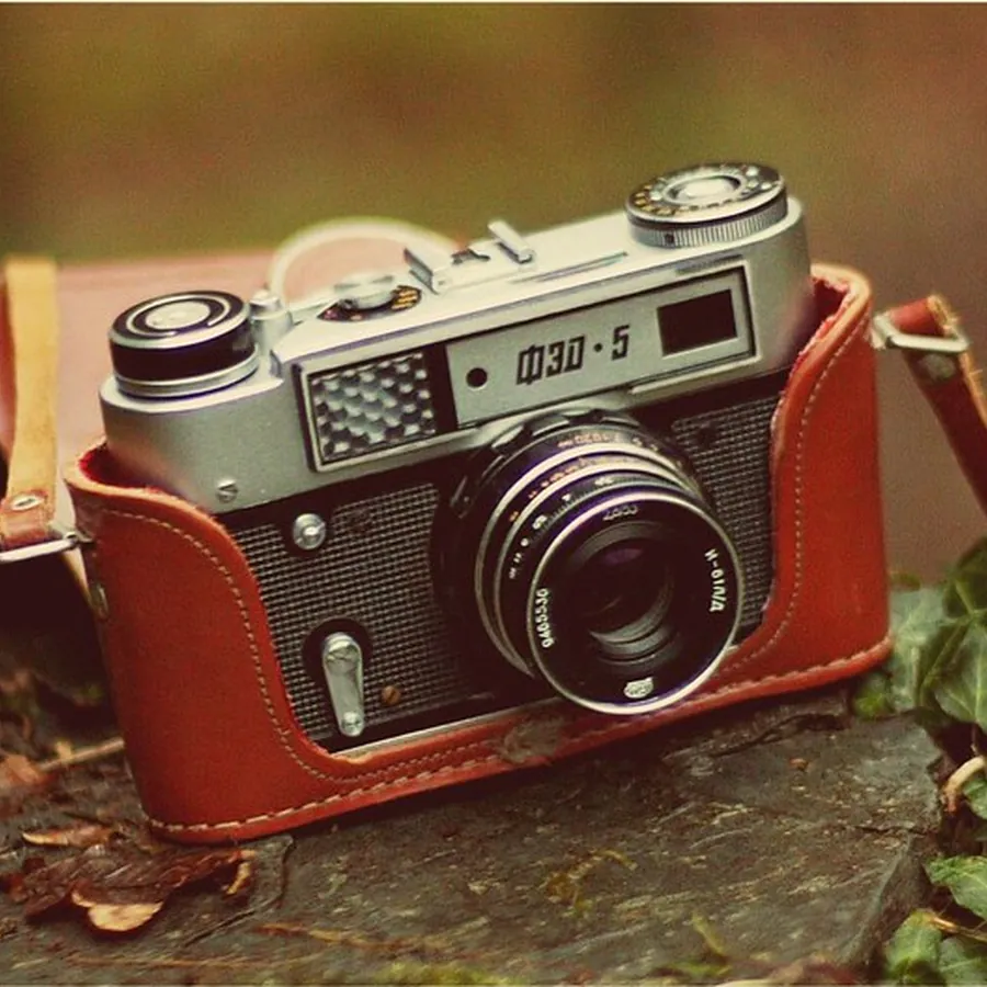 Vintage rangefinder camera in a brown leather case