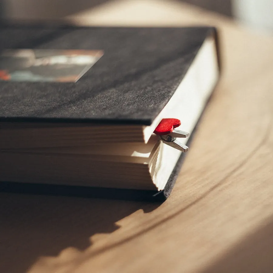 Dark cloth hardcover with a red ribbon marker