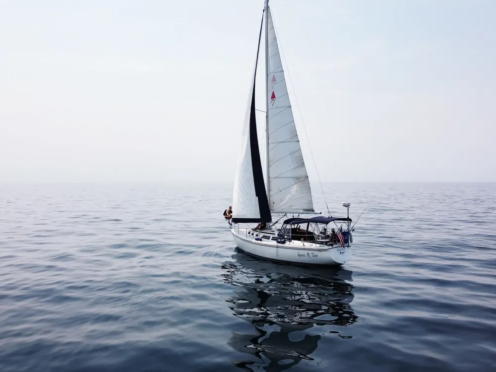 Cruising sloop on calm water