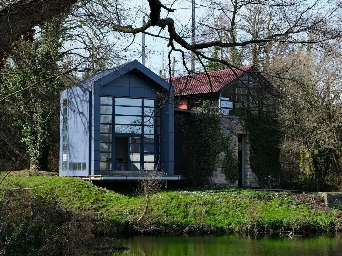 Black timber and glass cabin on a lake