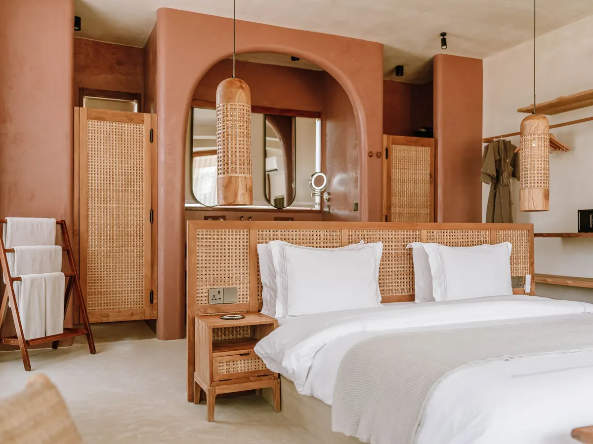 Warm boutique hotel room with linen and oak