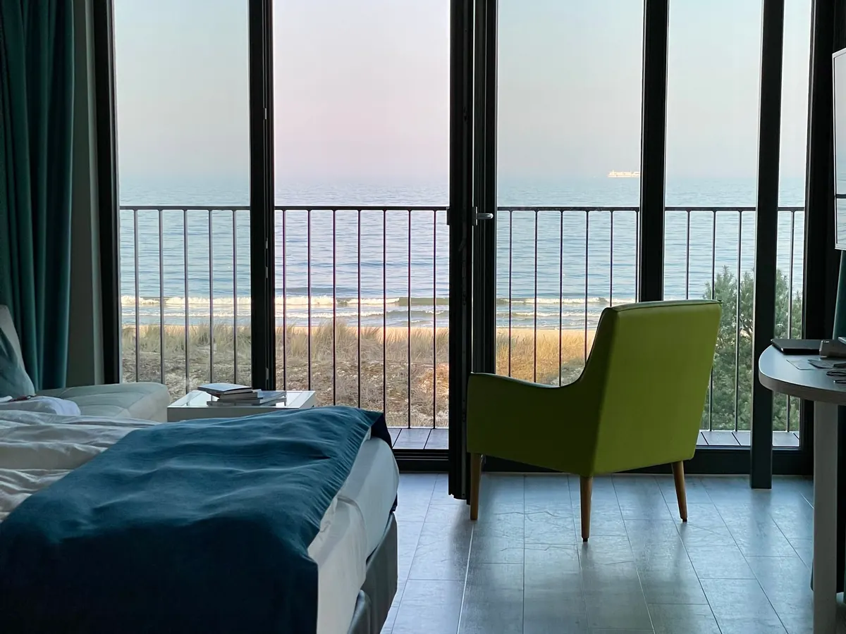 Hotel room with balcony doors to the sea