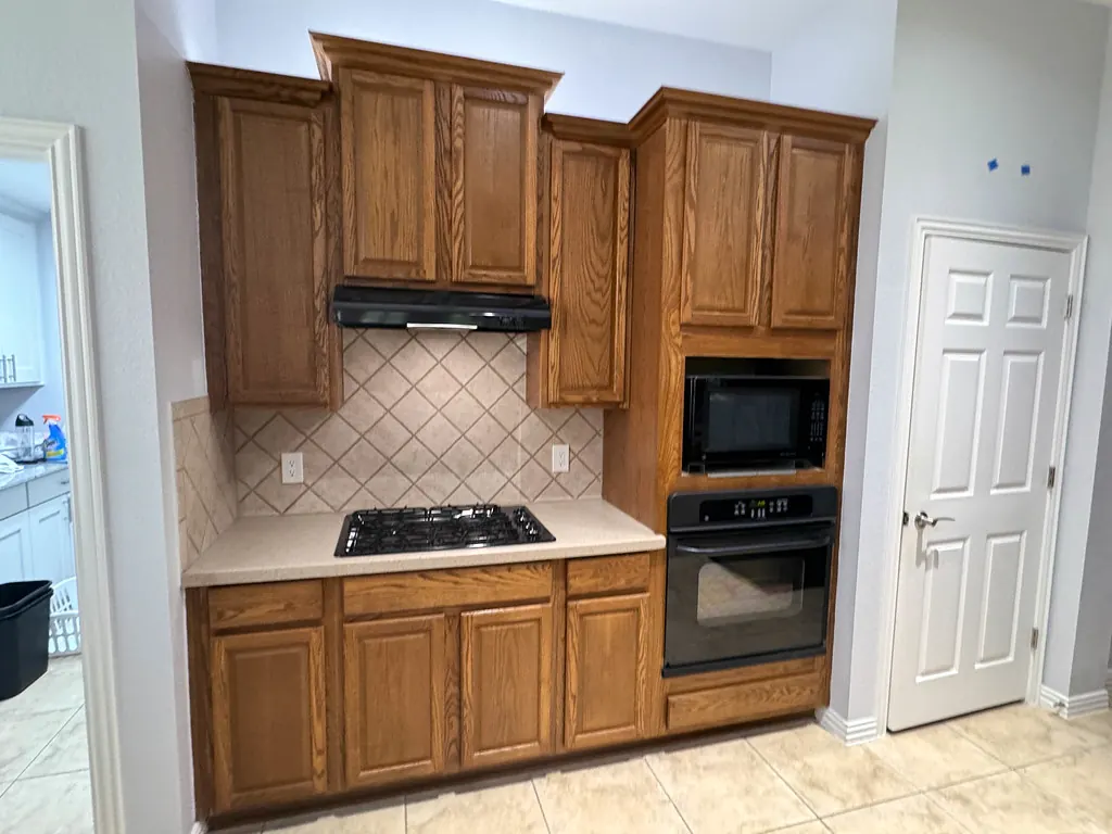 Kitchen before the remodel: dated cabinets and dim lighting