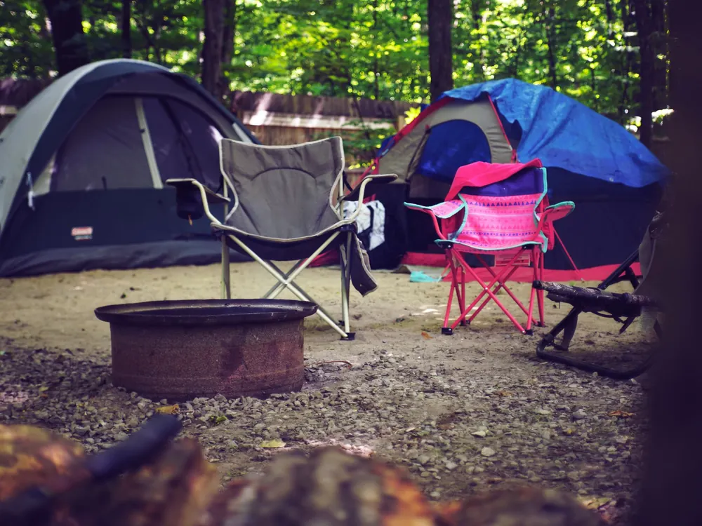 Campsite with chairs and a fire pit