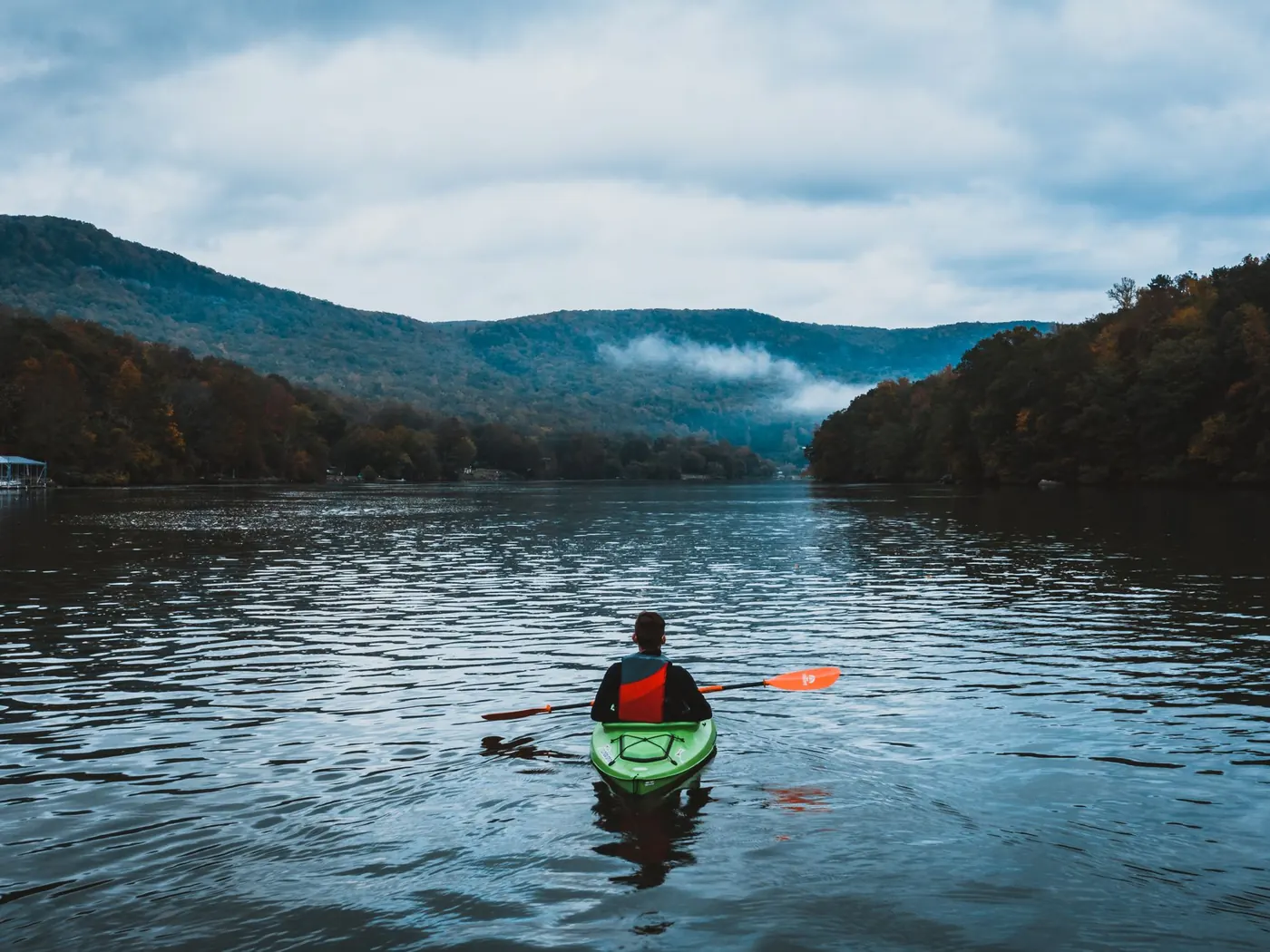 Kayaker on a misty mountain lake