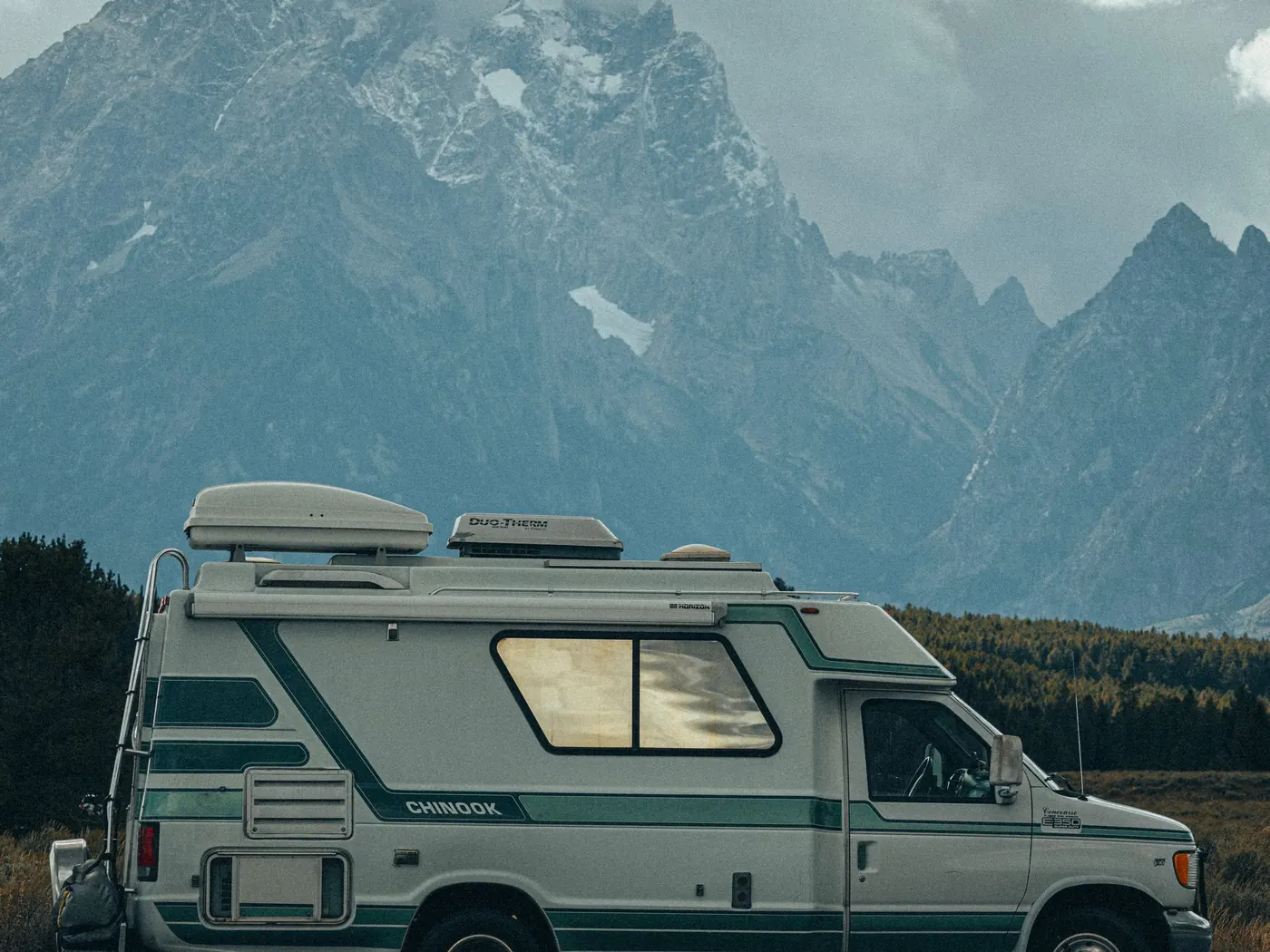 Camper van below snowy peaks