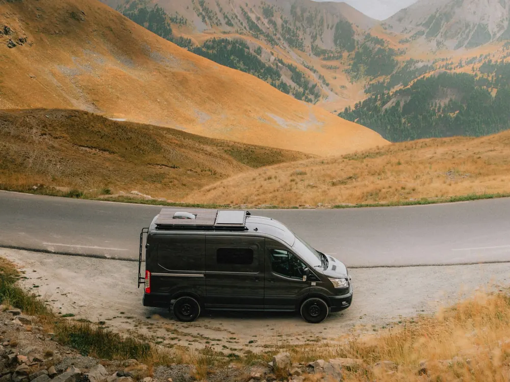 Dark camper van on a mountain pass