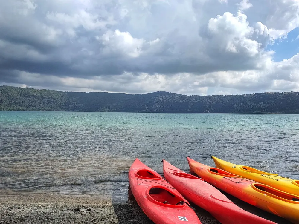 Colorful kayaks on a lakeshore