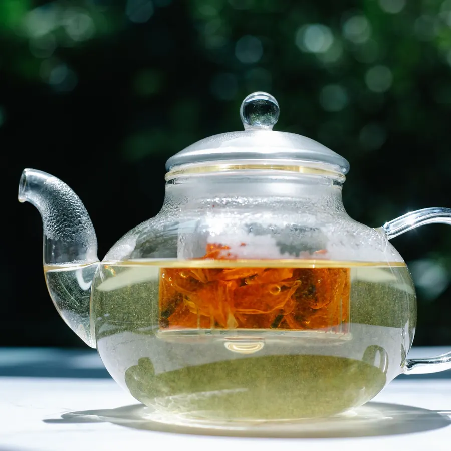 Glass teapot with infuser in sunlight