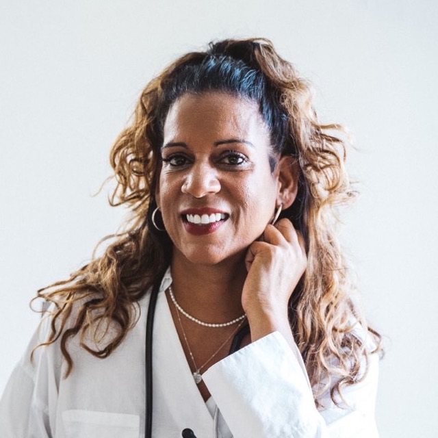 Portrait of a smiling facial plastic surgeon in a white coat