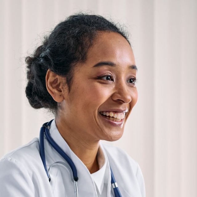 Portrait of a smiling aesthetic dermatologist in a white coat